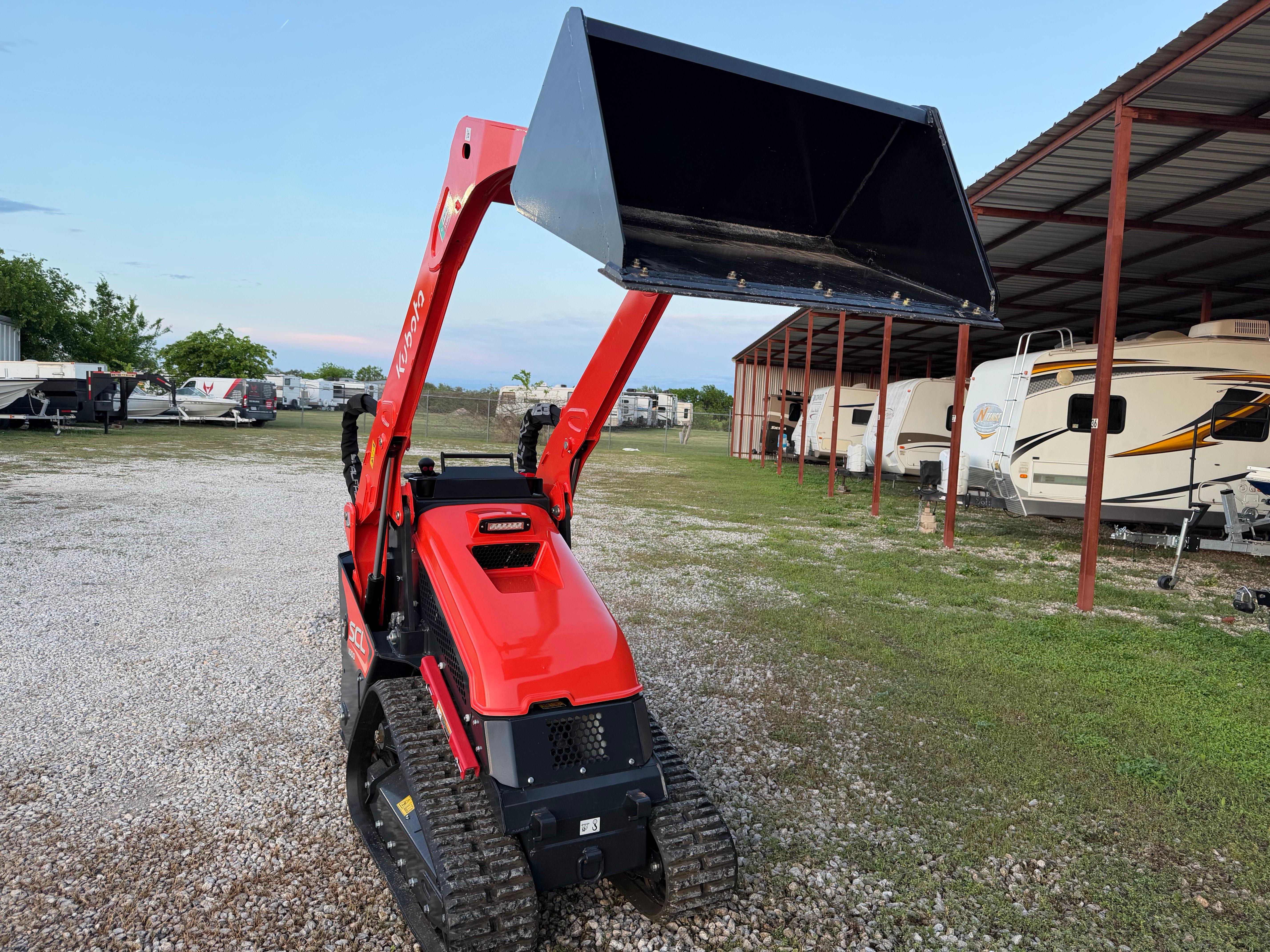Kubota SCL1000 mini skid steer rental with attachments in Leander TX